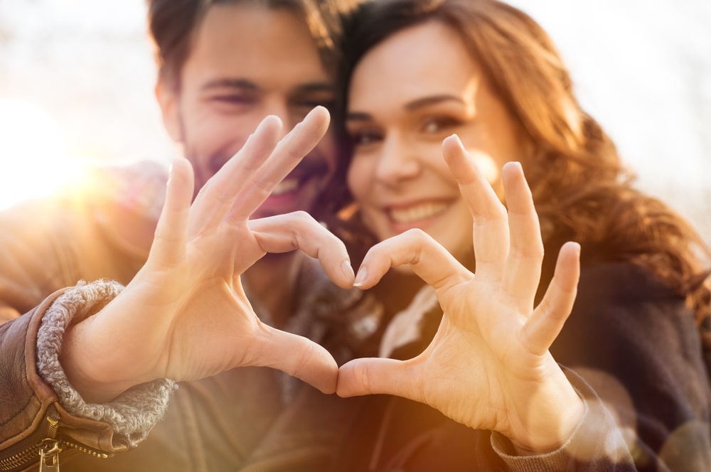 Romantic Getaway in Nashville, photo of a happy couple making a heart with their hands